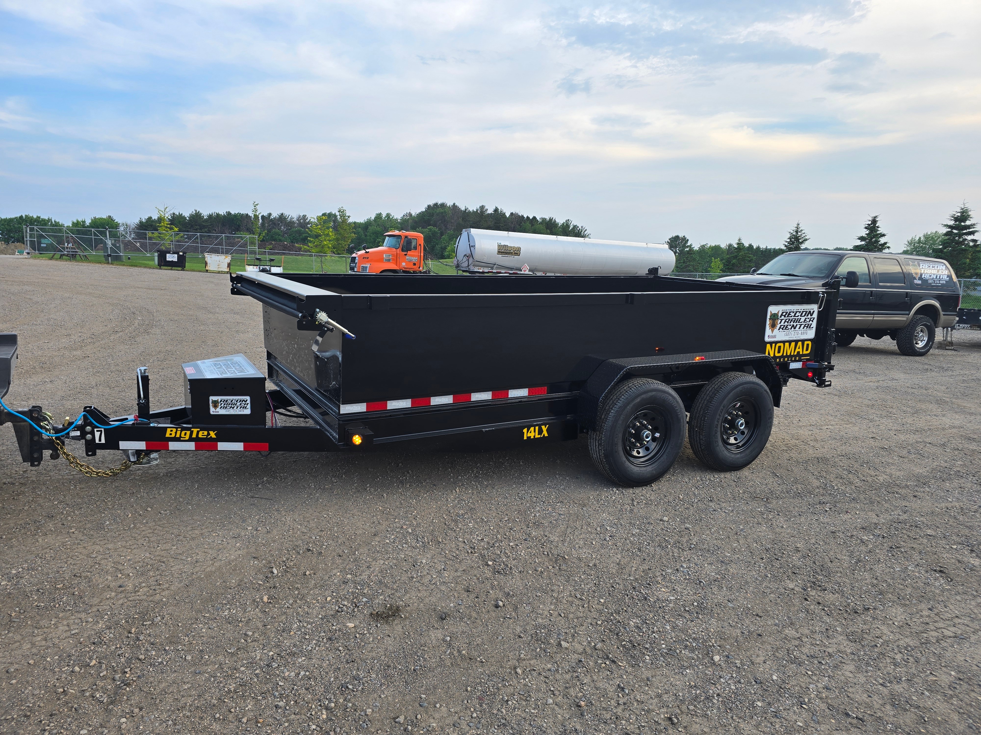 BigTex dump trailer rear view showing hydraulic lift system and high sides