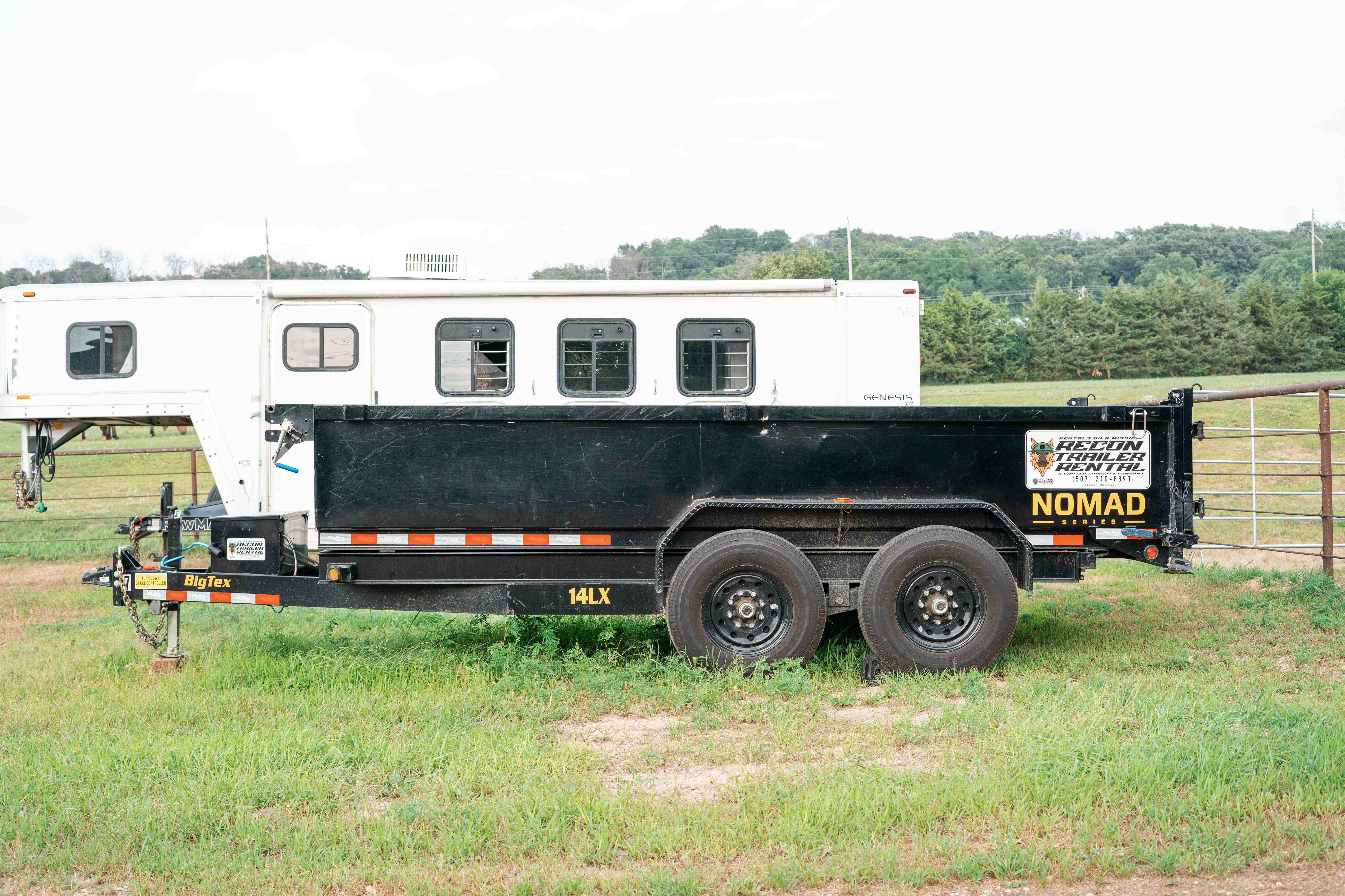 Close-up of BigTex dump trailer tailgate showing NOMAD series branding and Recon Trailer Rental sticker
