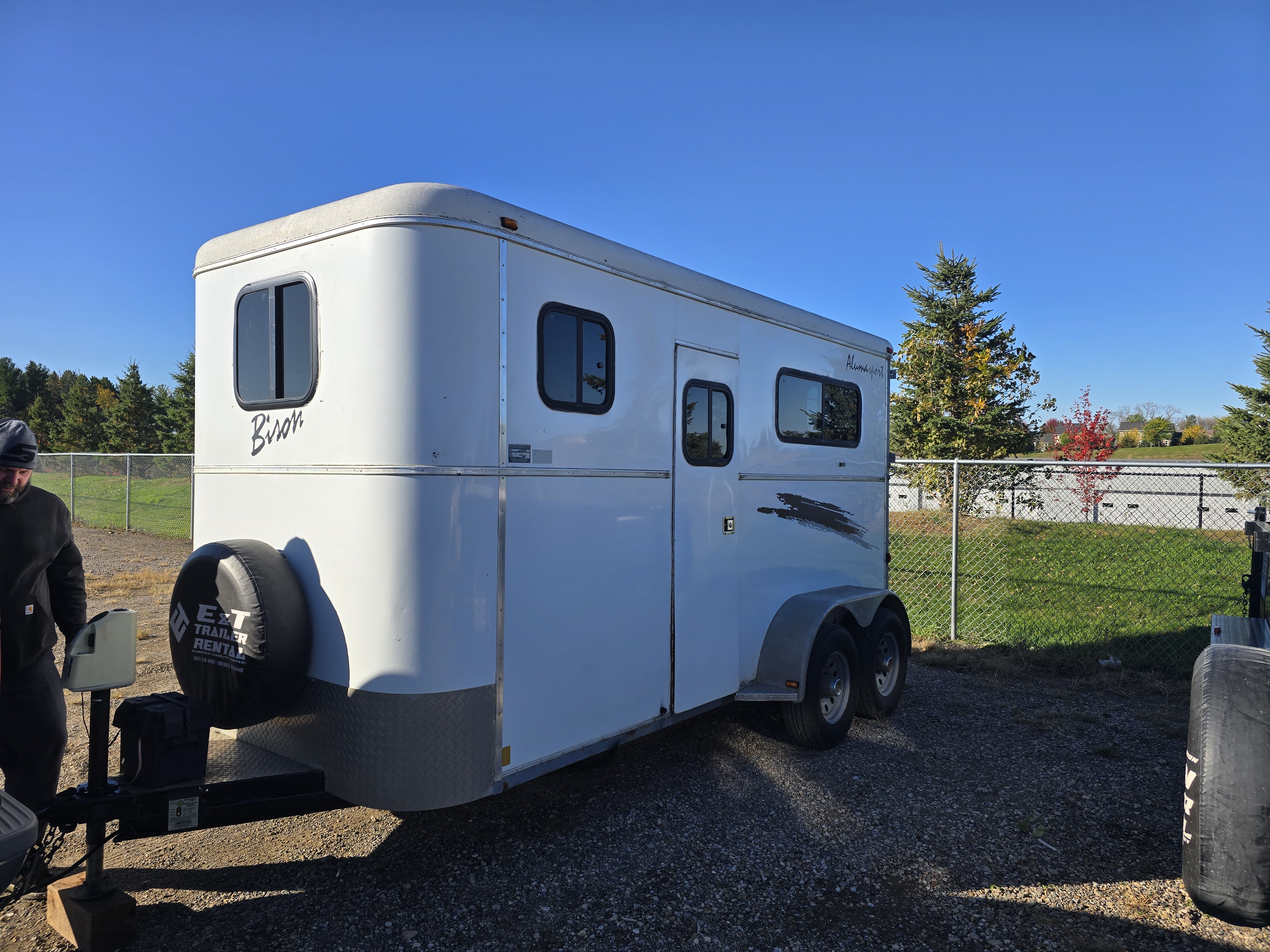 Bison horse trailer front angle showing aluminum exterior and windows