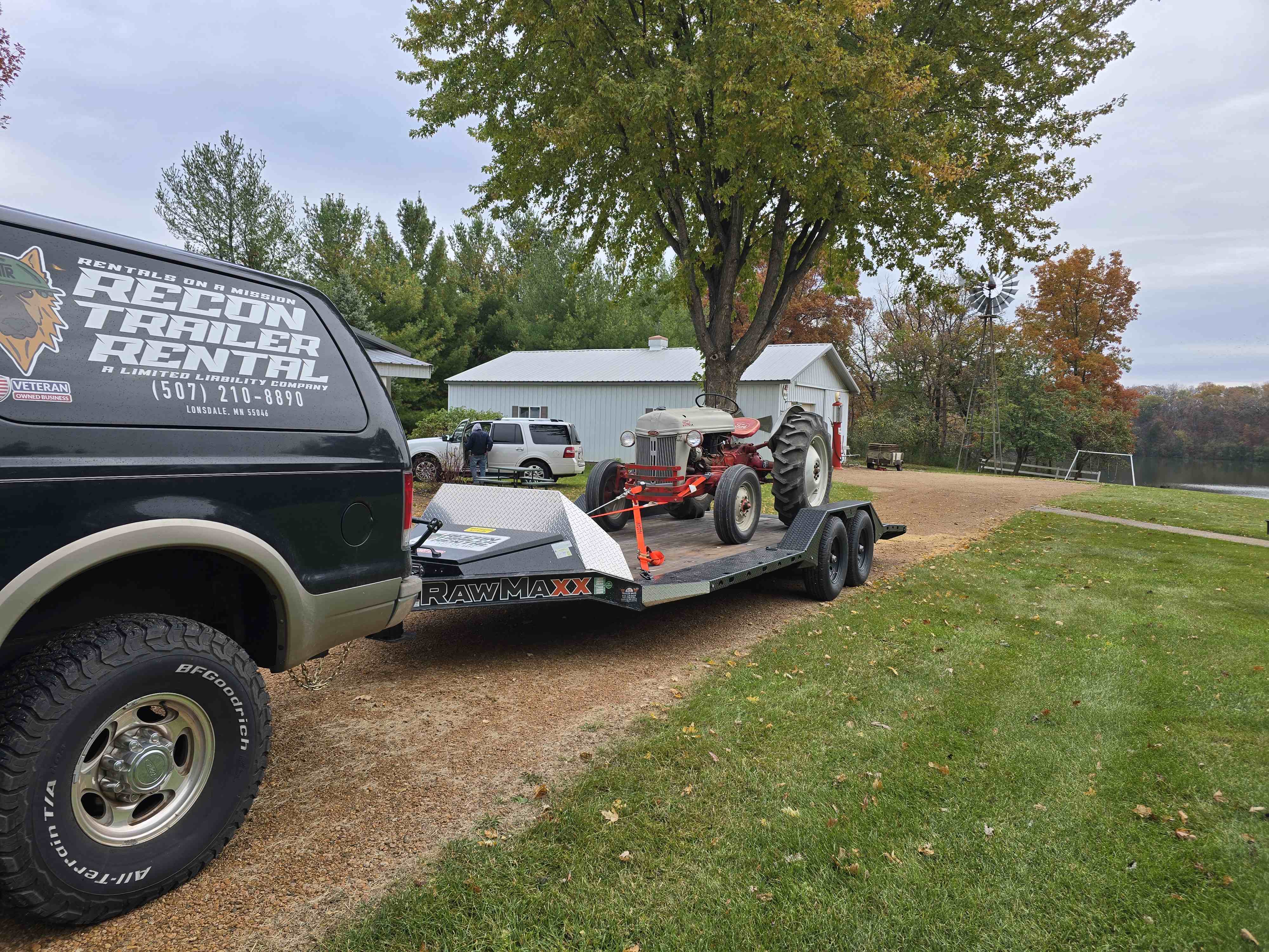 Rawmaxx 10K car trailer angle view with electric brakes and dual axles