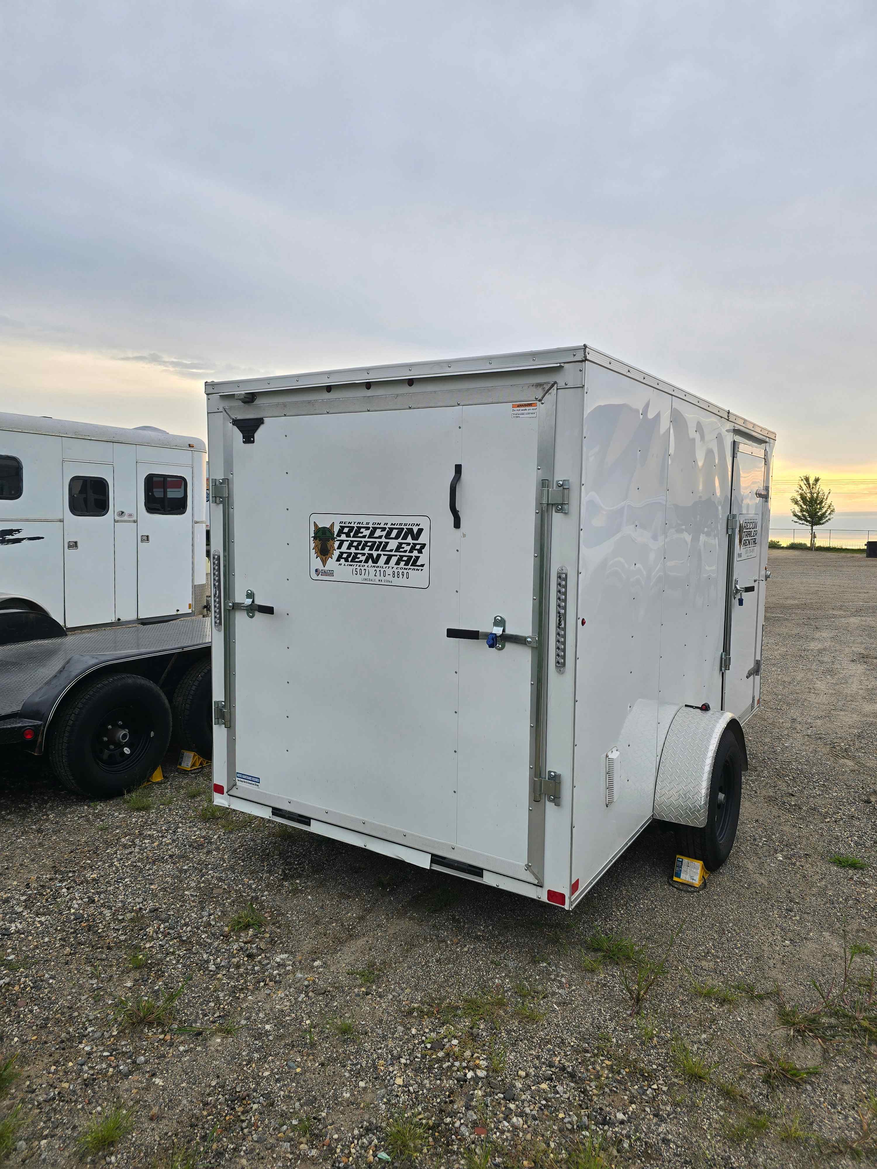 6x12 enclosed cargo trailer interior with ramp down and measuring tape