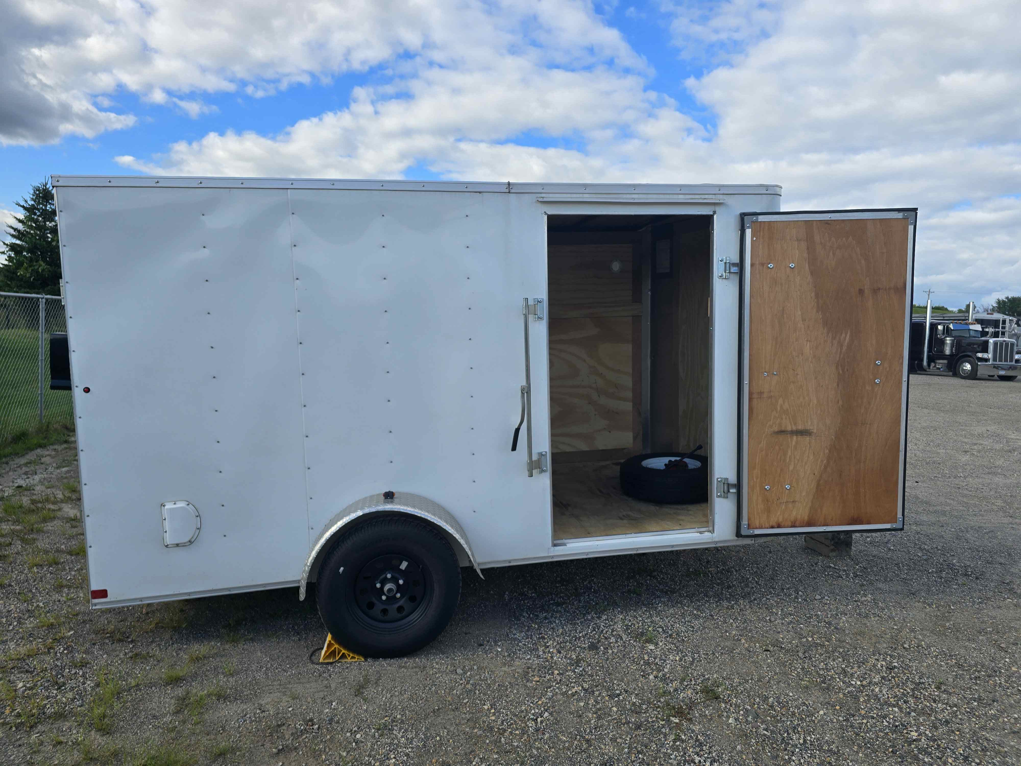 Front view of the 6x12 enclosed cargo trailer with branded doors open