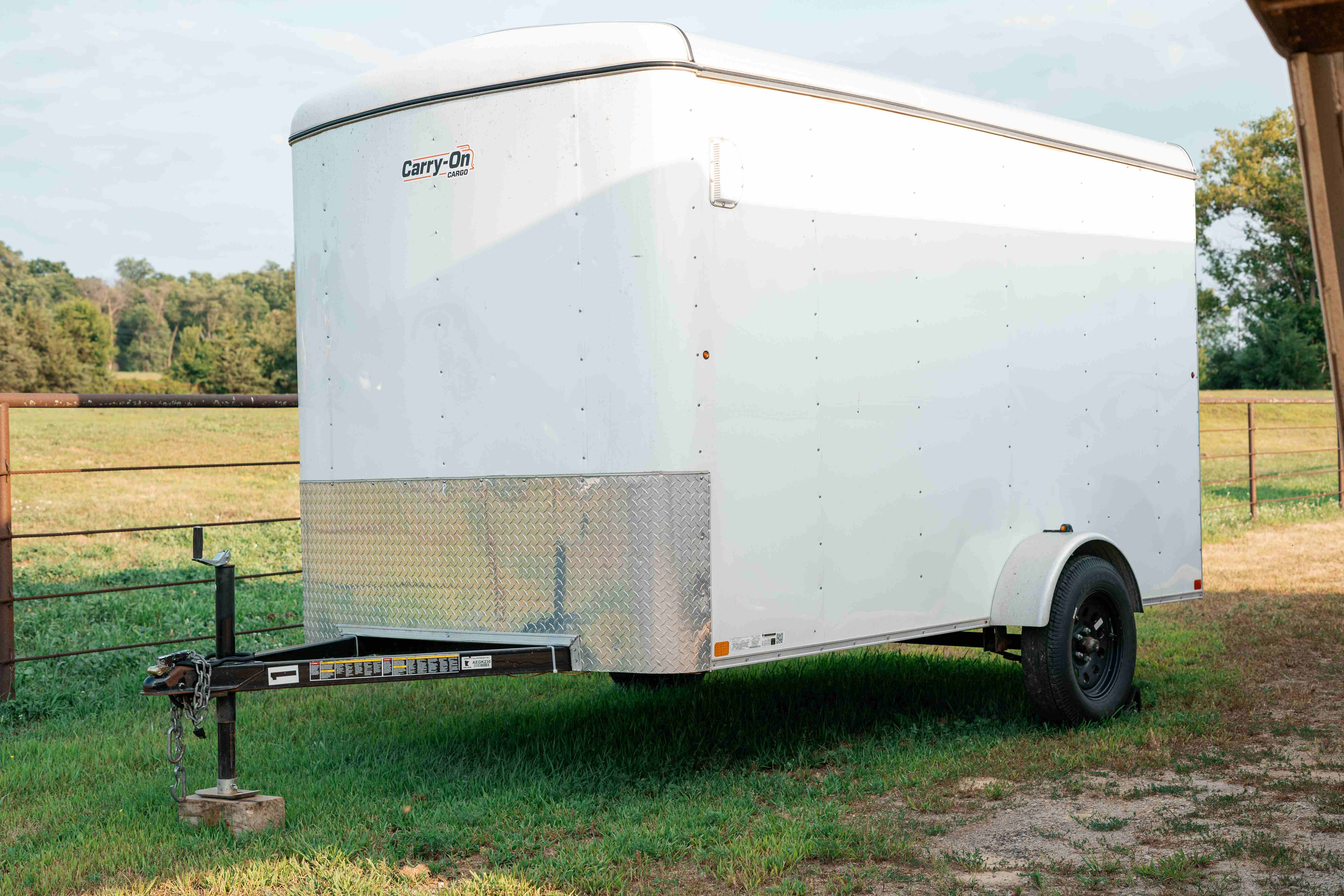 Wide exterior view of the 6x12 enclosed cargo trailer with side door open
