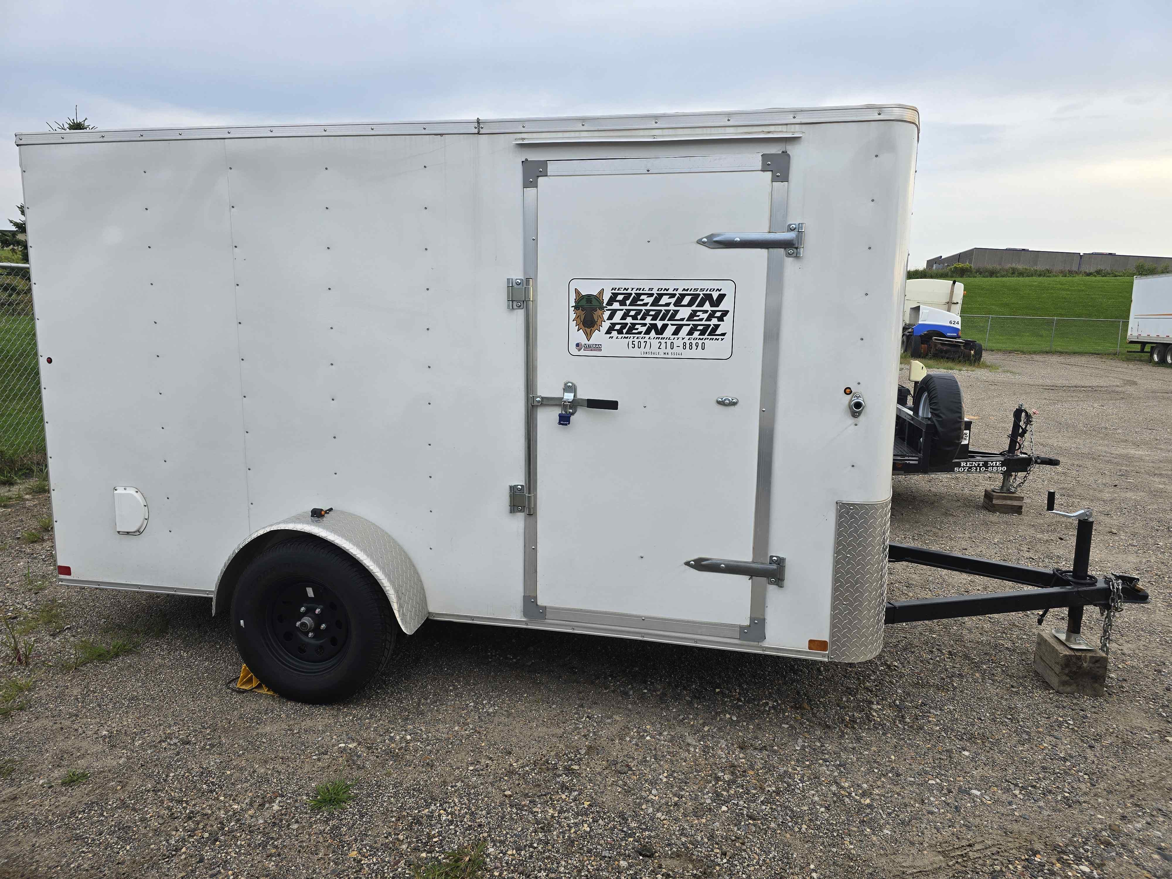 Wide exterior side view of the 6x12 enclosed cargo trailer with side door closed