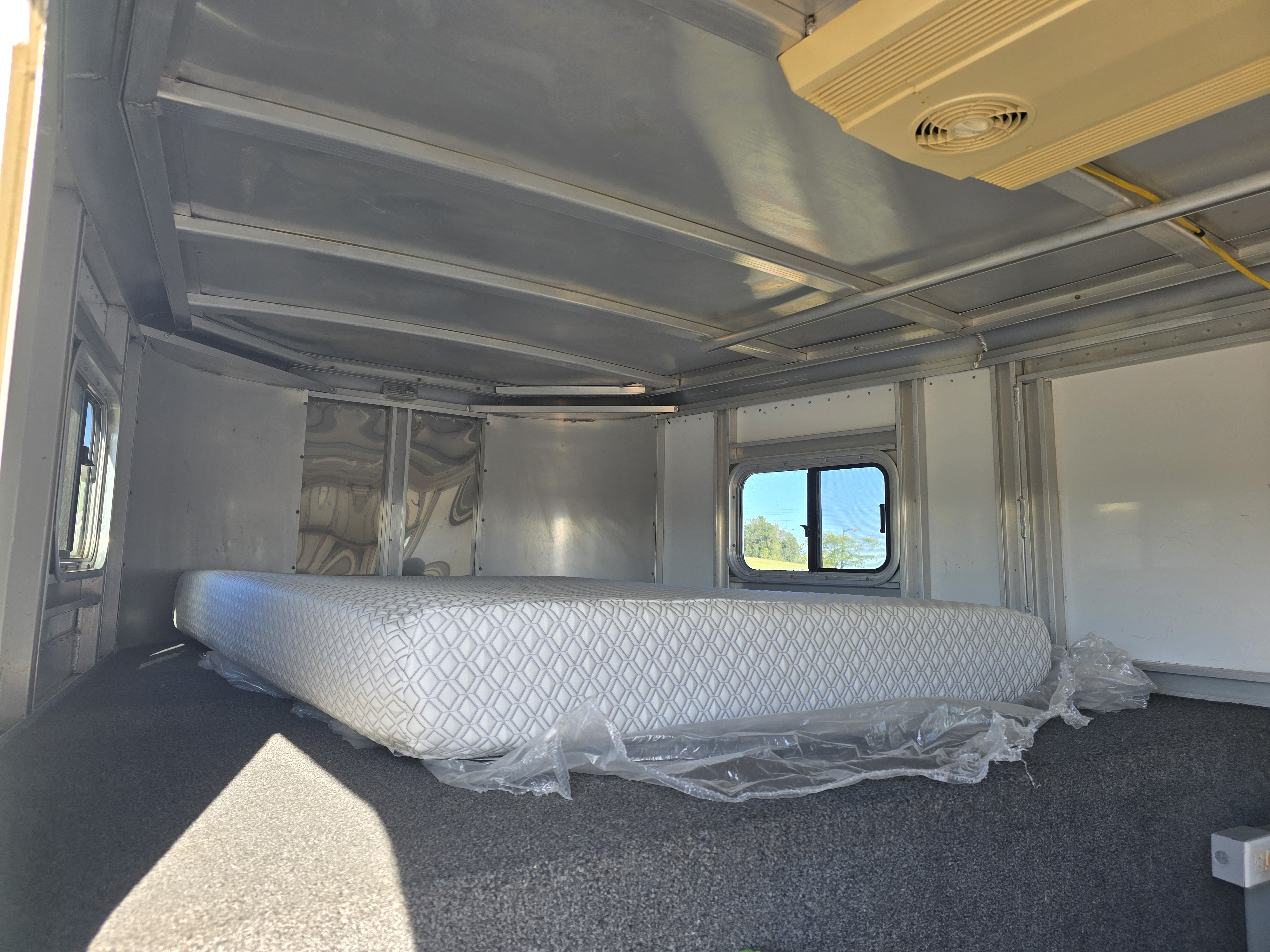 Exiss horse trailer interior living quarters with mattress and storage