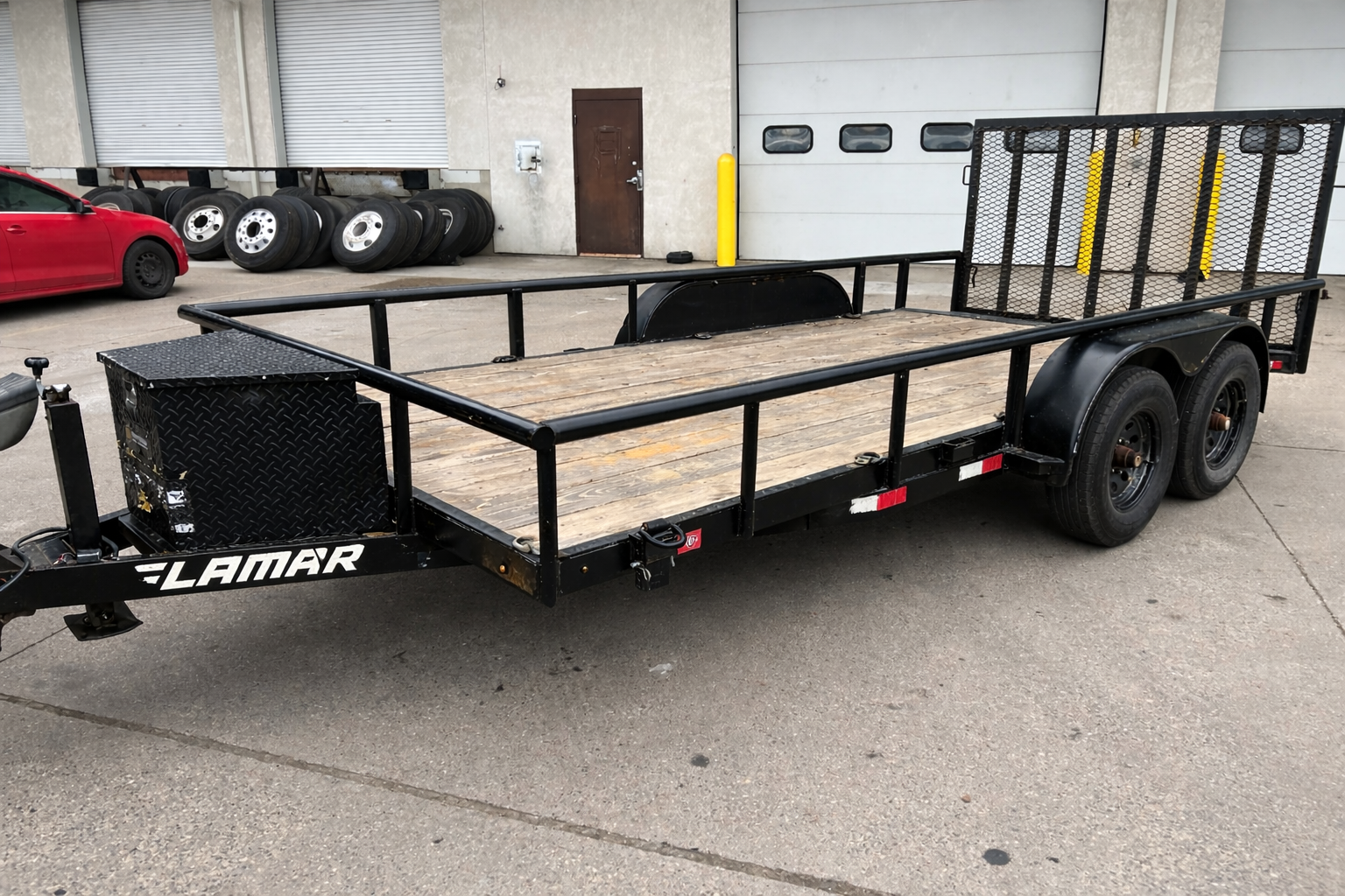 7x16 Lamar black steel utility trailer with wood deck, mesh sides, dual axles, and toolbox - rental in Cannon Falls MN