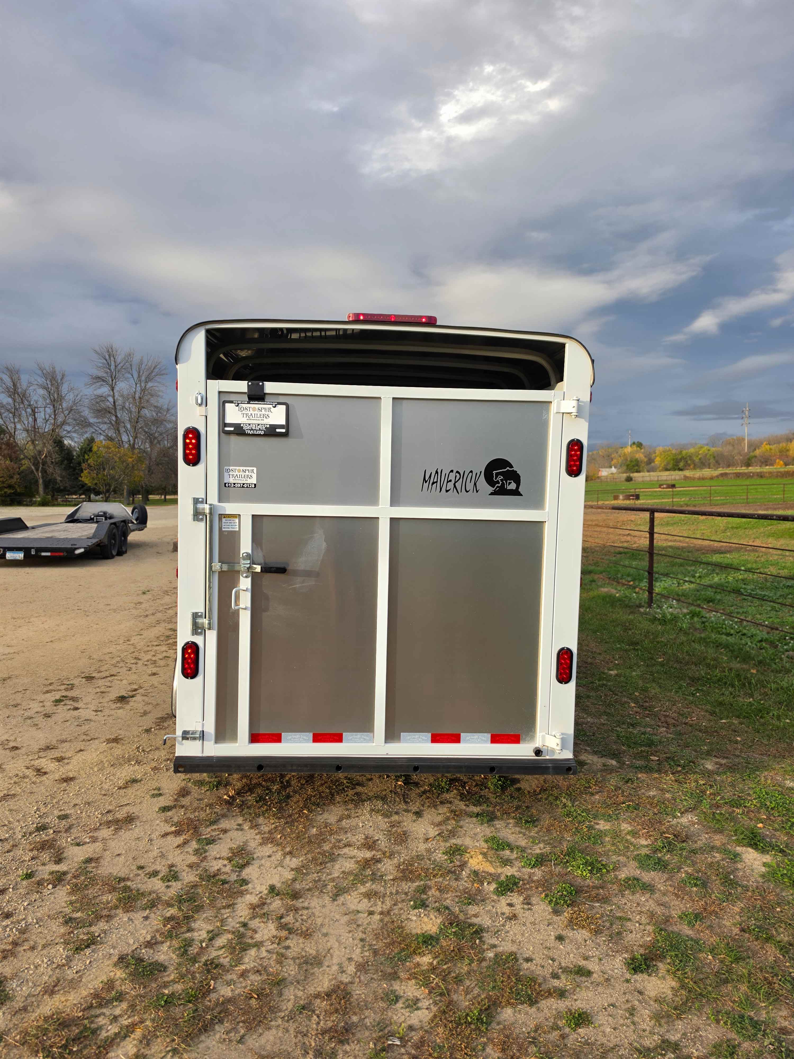 Rear view of the Maverick 3 horse stock combo trailer showing the split rear doors and taillights